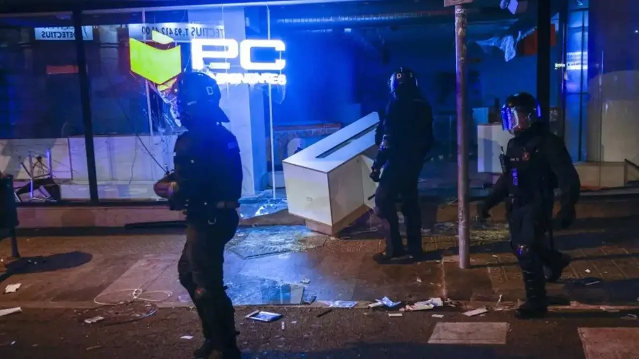Contenedores en llamas y presencia policial durante los disturbios registrados en las calles del centro de Barcelona.