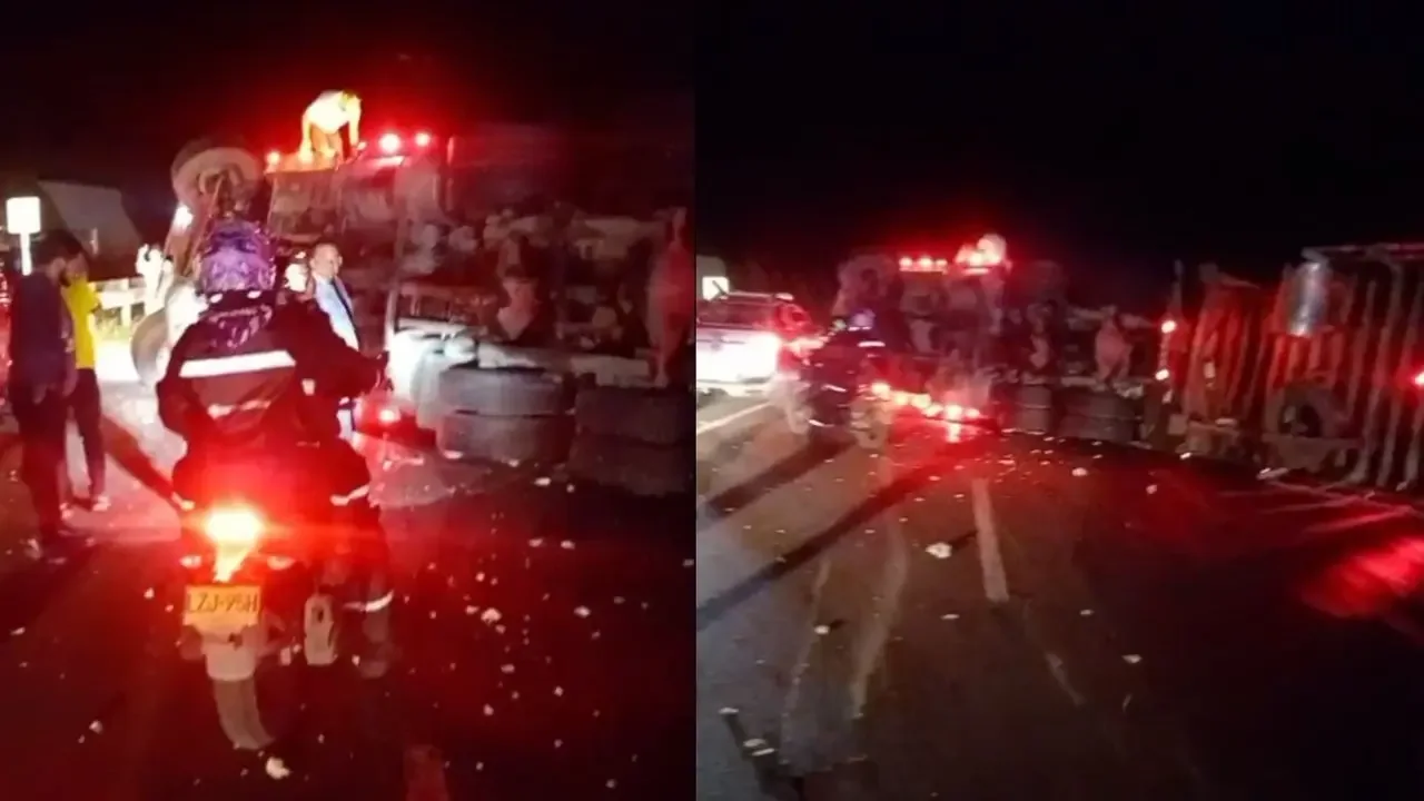 Vehículo de carga volcado en la vía Bogotá-Girardot con personal de asistencia vial retirando escombros de la calzada.
