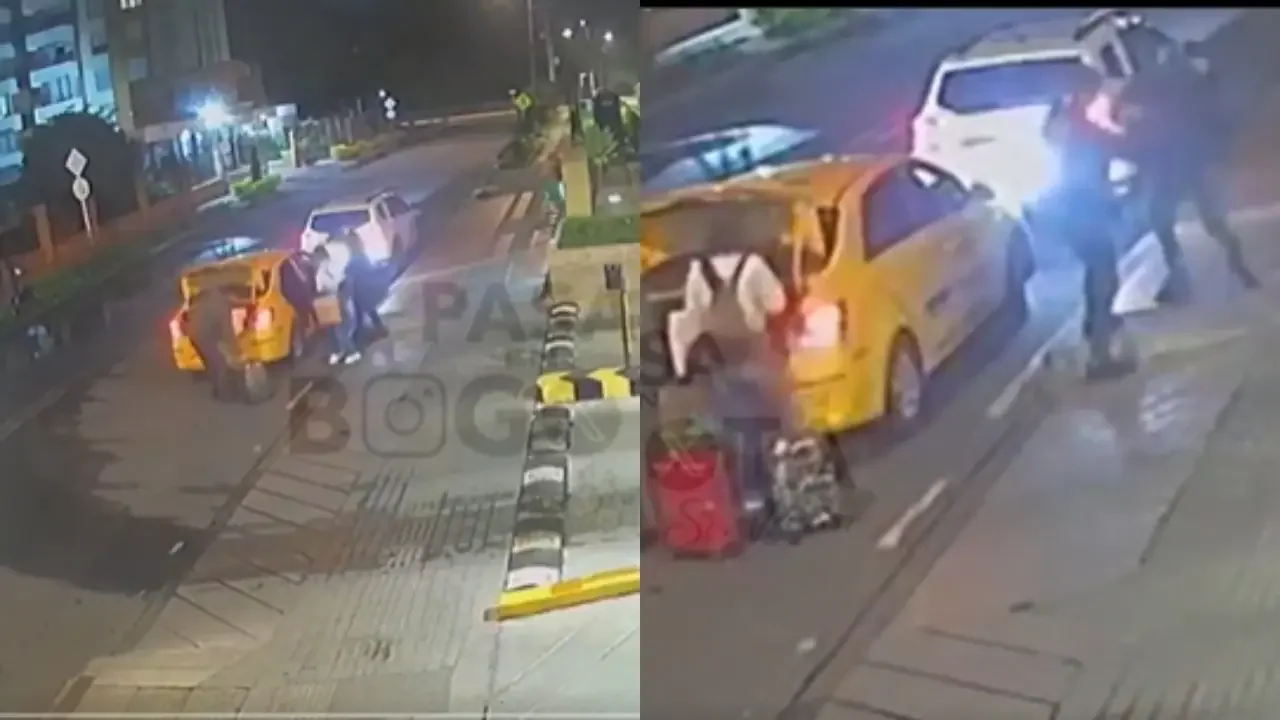 Captura de cámara de seguridad durante un robo a mano armada a una pareja frente a un conjunto residencial en Bogotá.